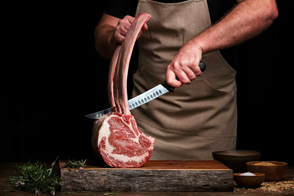 A butcher with a tomahawk steak (placeholder photograph)