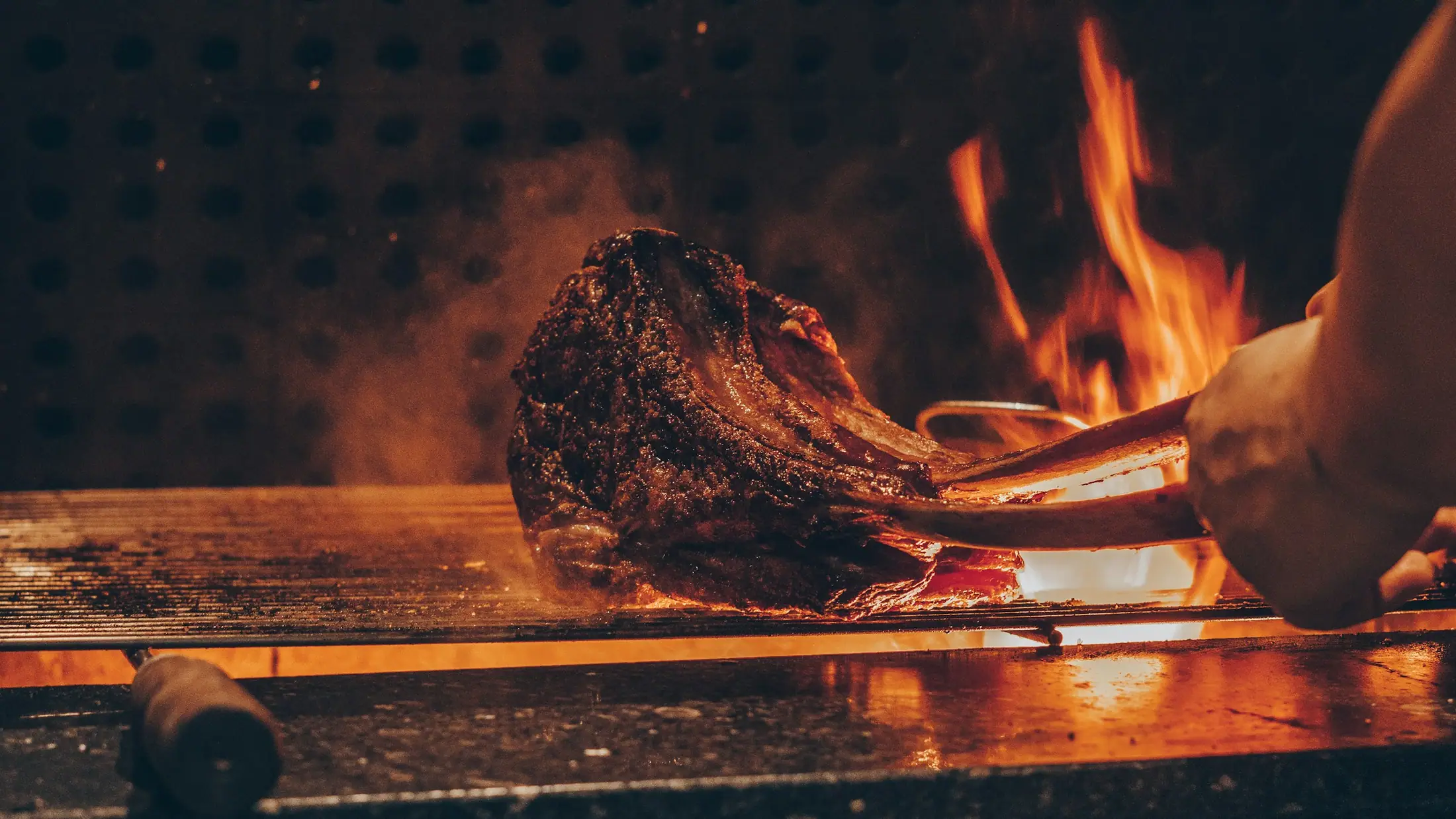 A tomahawk steak over open flame (placeholder photograph)