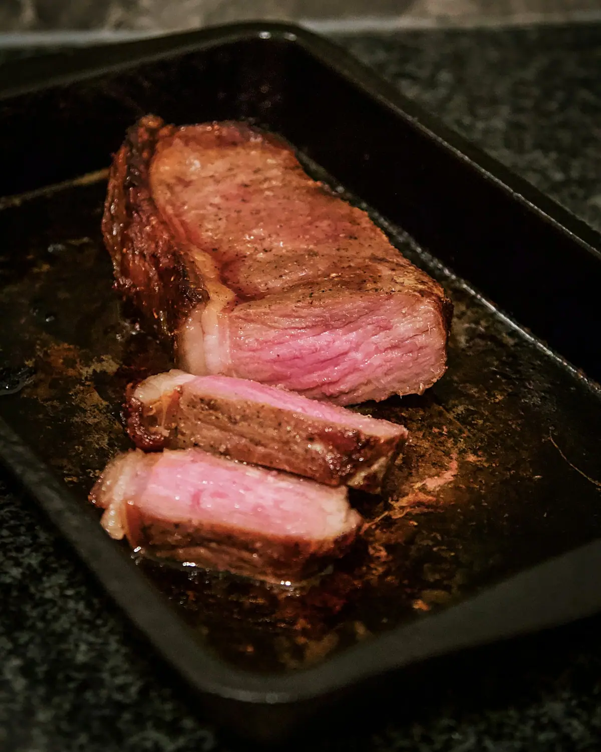 Sliced prime rib on a black tray (placeholder photograph)